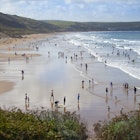 People enjoying the surfing beach of Woolacombe